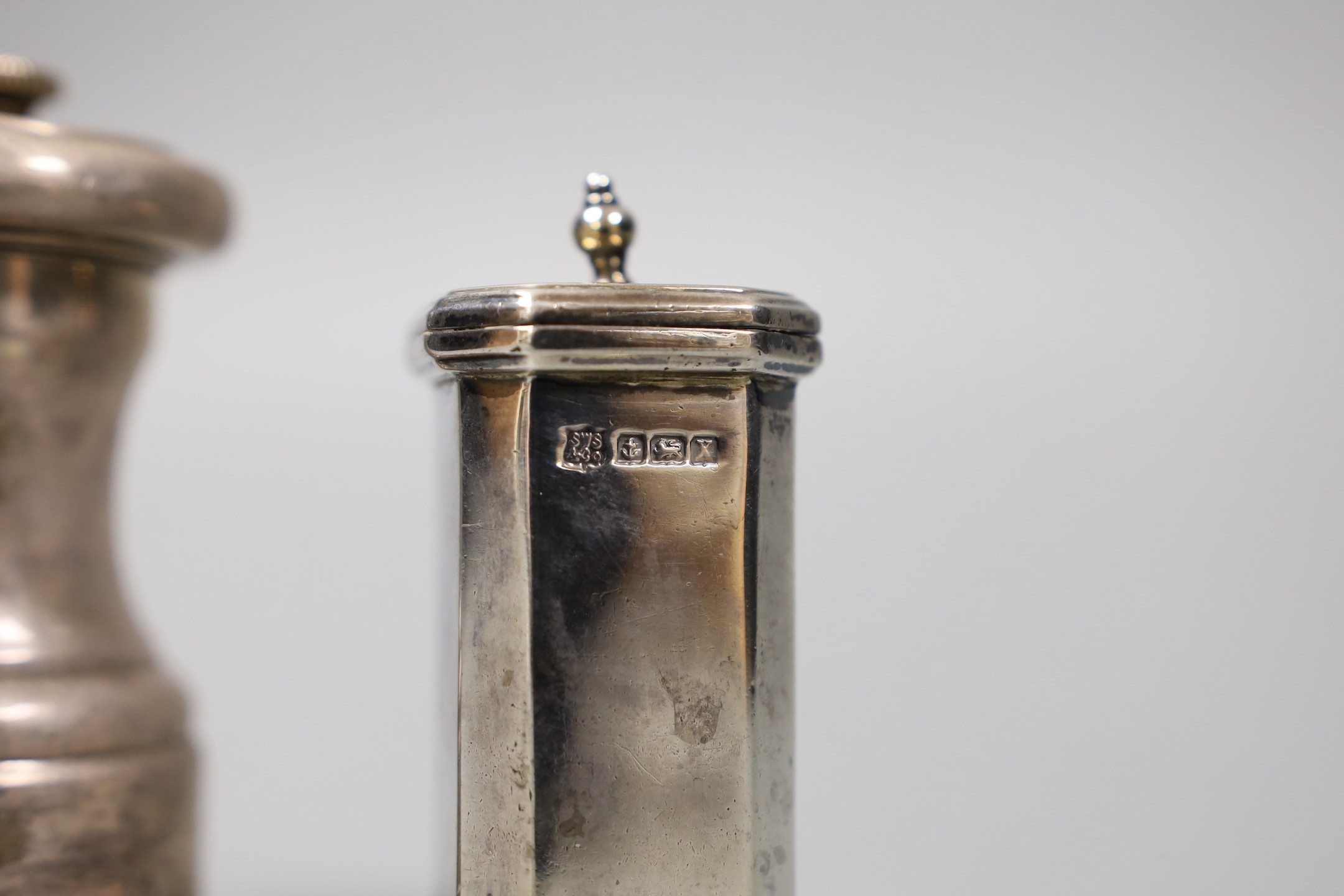 A pair of George V silver pepperettes, Birmingham, 1922, 72mm and a late Victorian silver pepper mill, Hukin & Heath, London, 1896.